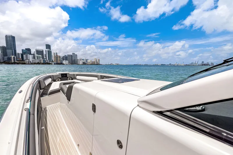 Slide: The Image of Cigarette 42 Auroris 2022 boat cruising near city skyline under blue sky. - 23