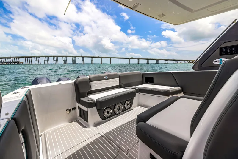 Slide: The Image of 2022 Cigarette 42 Auroris boat interior with seating, ocean view, and bridge in the background. - 33