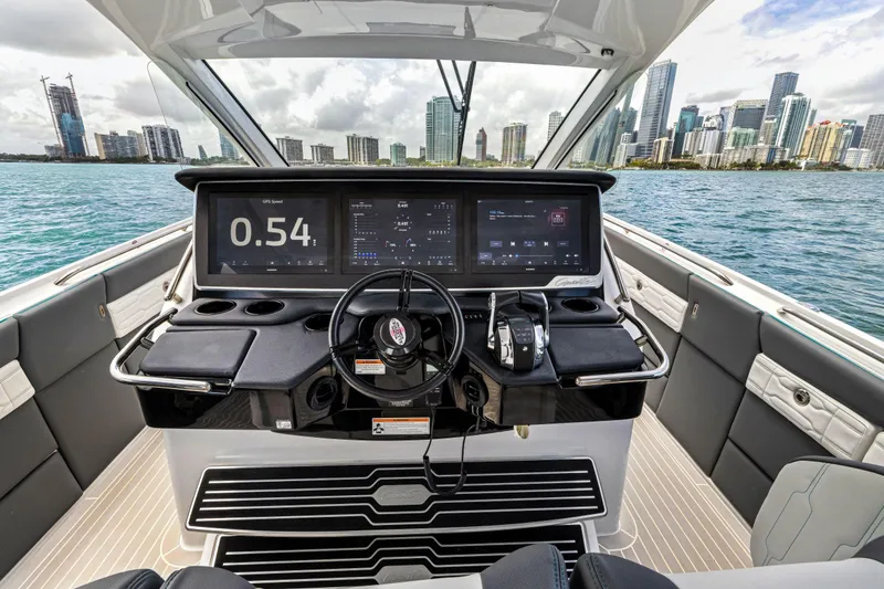Slide: The Image of 2022 Cigarette 42 Auroris boat dashboard with city skyline in background. - 38