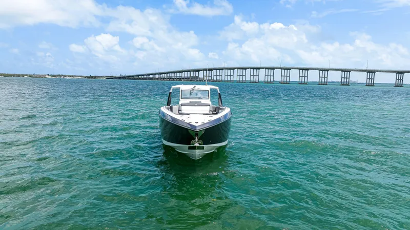 Slide: The Image of 2022 Cigarette 42 Auroris boat on clear water with bridge in background. - 4