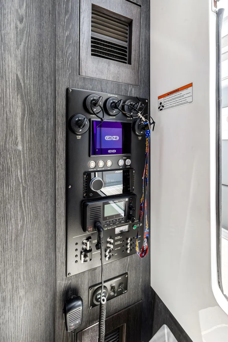 Slide: The Image of Control panel inside 2022 Cigarette 42 Auroris boat, featuring navigation and communication equipment. - 46