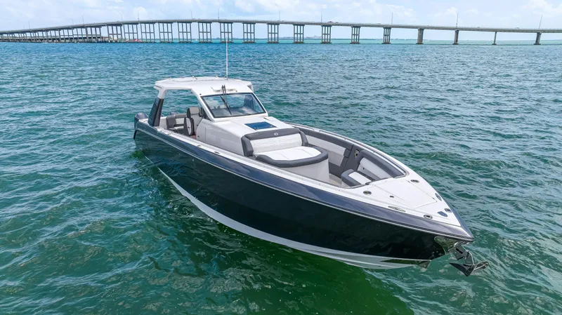 Slide: The Image of 2022 Cigarette 42 Auroris boat on open water near a bridge. - 9