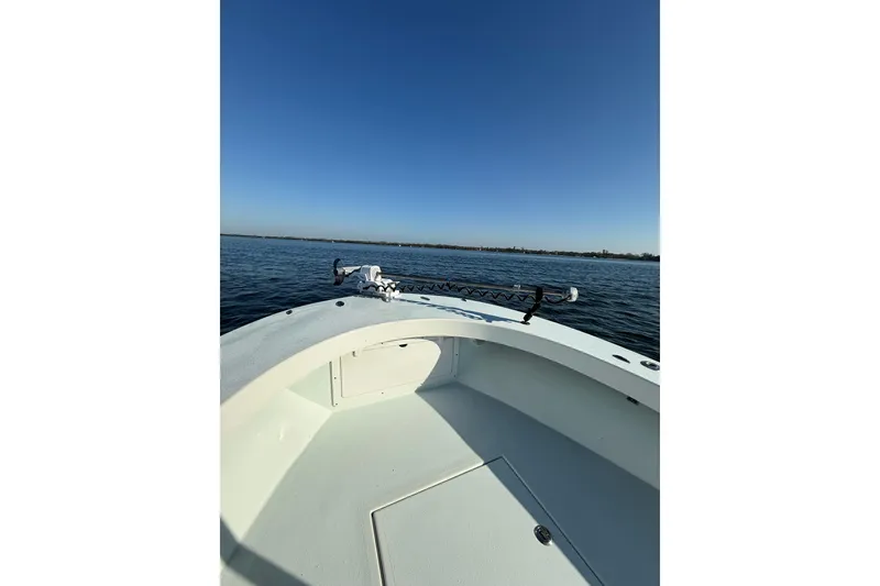 Slide: The Image of 1987 Privateer 22 Roamer boat on calm water under clear blue sky. - 10