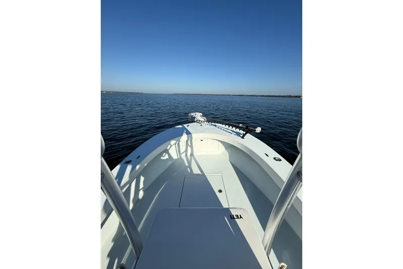 Slide: The Image of 1987 Privateer 22 Roamer boat on calm water under clear blue sky. - 12