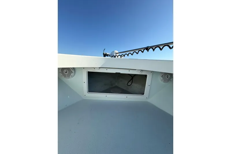 Slide: The Image of 1987 Privateer 22 Roamer boat interior with speakers and hatch under clear blue sky. - 14