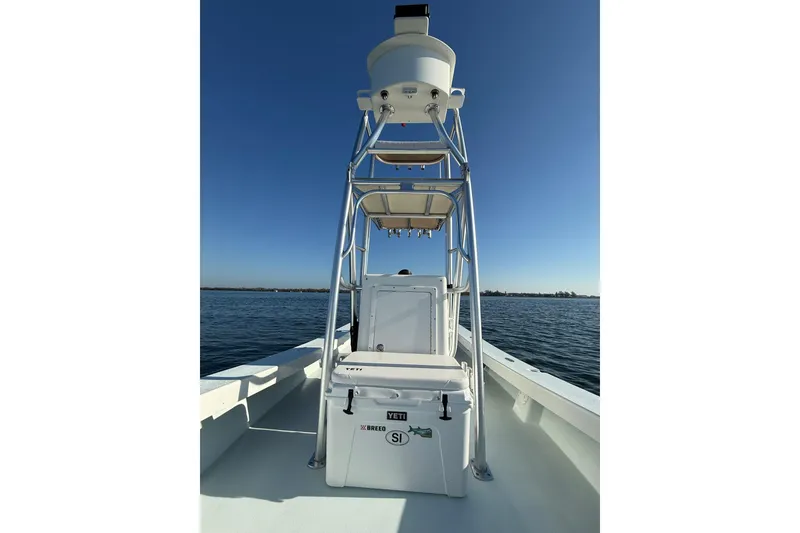 Slide: The Image of 1987 Privateer 22 Roamer boat on calm water under clear blue sky. - 18