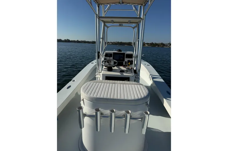 Slide: The Image of 1987 Privateer 22 Roamer boat interior with steering console on calm water. - 19
