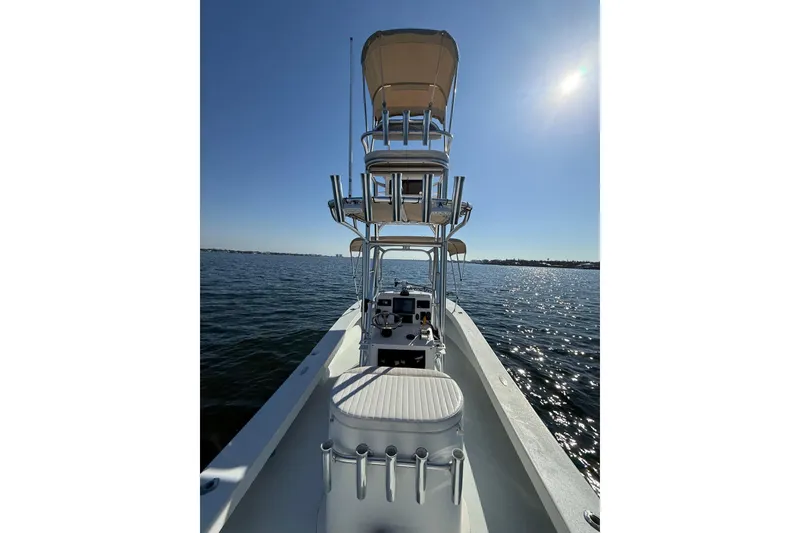 Slide: The Image of 1987 Privateer 22 Roamer boat on calm water under clear blue sky. - 26