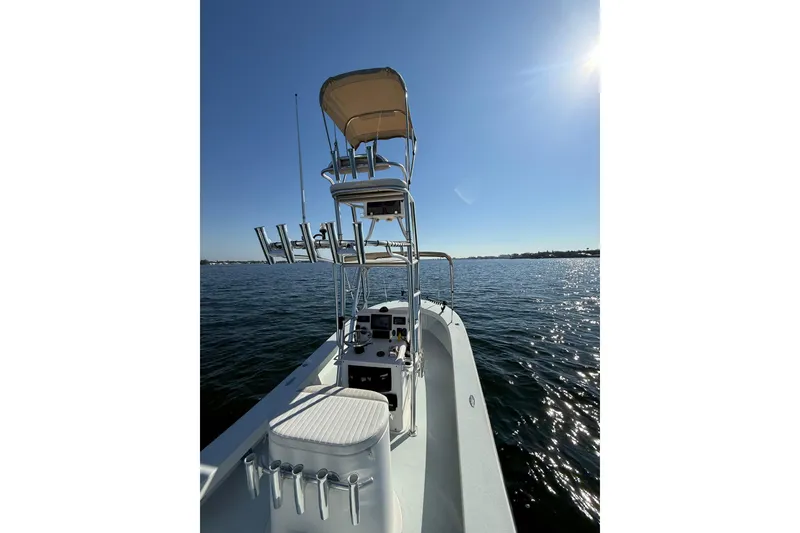 Slide: The Image of 1987 Privateer 22 Roamer boat on calm water under clear blue sky. - 27