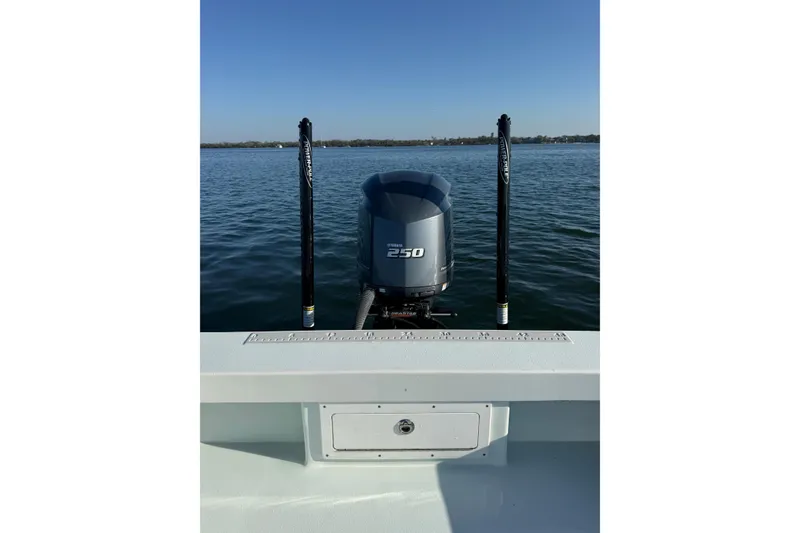 Slide: The Image of 1987 Privateer 22 Roamer boat with 250 horsepower engine on calm water. - 28