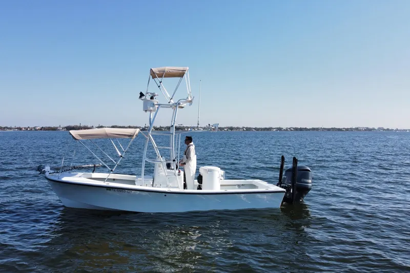 Slide: The Image of 1987 Privateer 22 Roamer boat on calm water with clear blue sky. - 3
