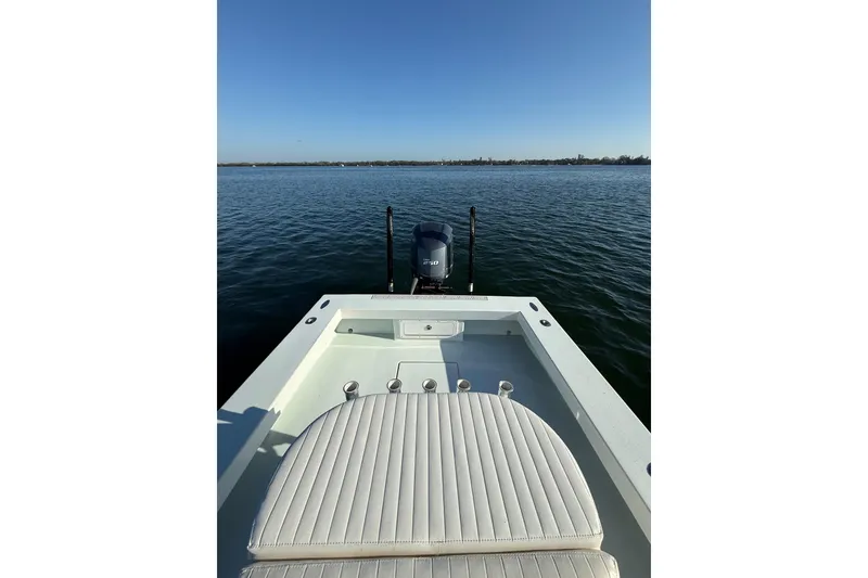 Slide: The Image of 1987 Privateer 22 Roamer boat on calm water with clear blue sky. - 30