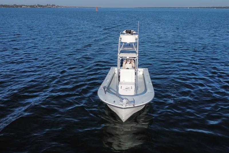 Slide: The Image of 1987 Privateer 22 Roamer boat on calm blue water, viewed from the front. - 4
