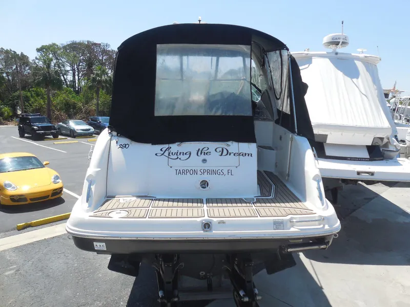 Slide: The Image of 2007 Sea Ray 290 Sundancer boat docked, rear view, "Living the Dream" text visible. - 22