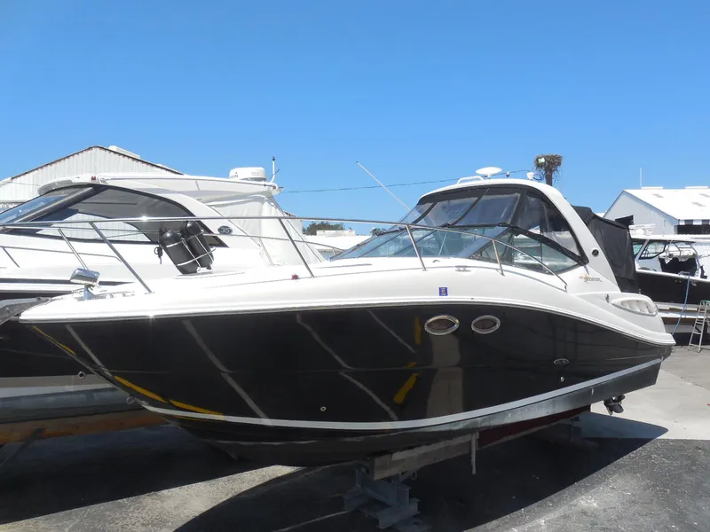 Slide: The Image of 2007 Sea Ray 290 Sundancer boat on display in a marina setting. - 23