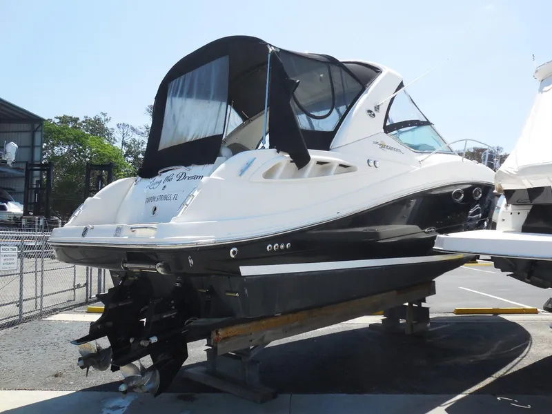 Slide: The Image of 2007 Sea Ray 290 Sundancer boat on display in a marina setting. - 3