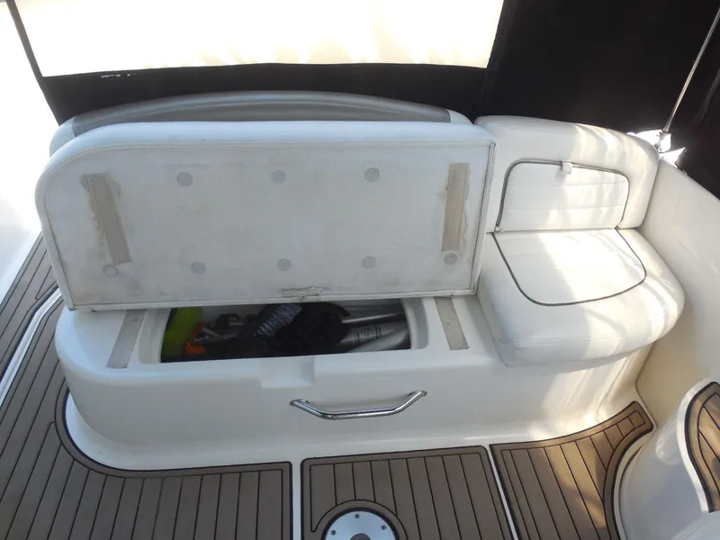 Slide: The Image of 2007 Sea Ray 290 Sundancer boat interior with open storage compartment and cushioned seating. - 37