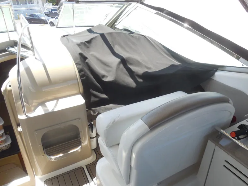 Slide: The Image of 2007 Sea Ray 290 Sundancer cockpit with covered dashboard and seating area. - 39