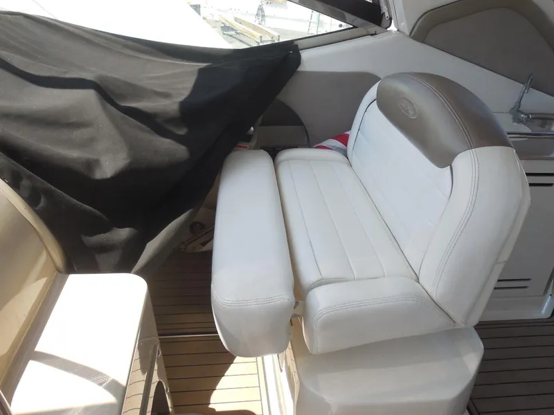 Slide: The Image of 2007 Sea Ray 290 Sundancer interior with white seating and wooden flooring. - 41