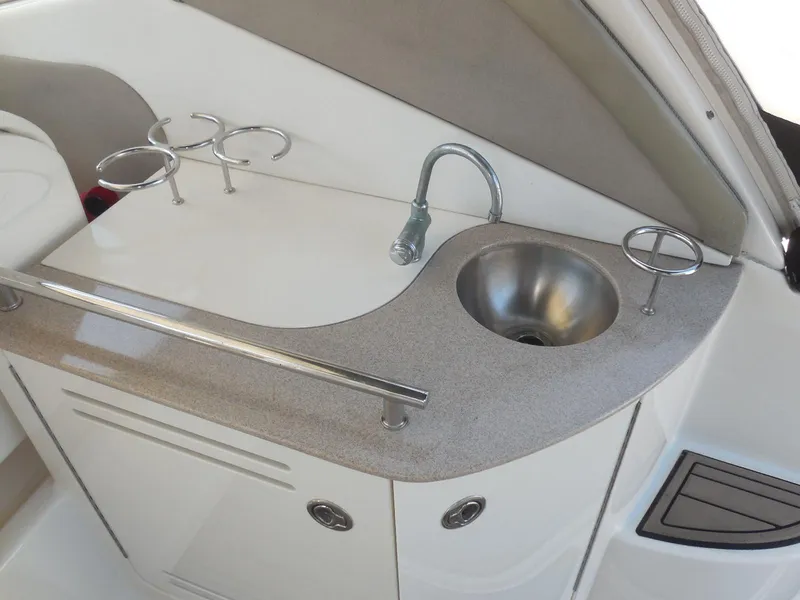 Slide: The Image of 2007 Sea Ray 290 Sundancer boat kitchenette with sink and cup holders. - 44