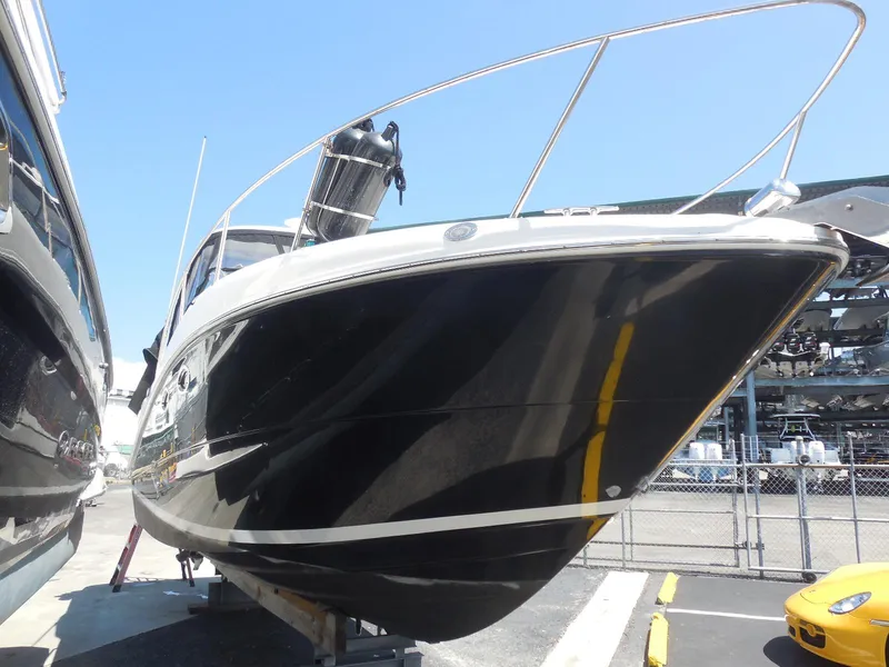 Slide: The Image of 2007 Sea Ray 290 Sundancer boat in a marina, black hull, docked on a sunny day. - 6