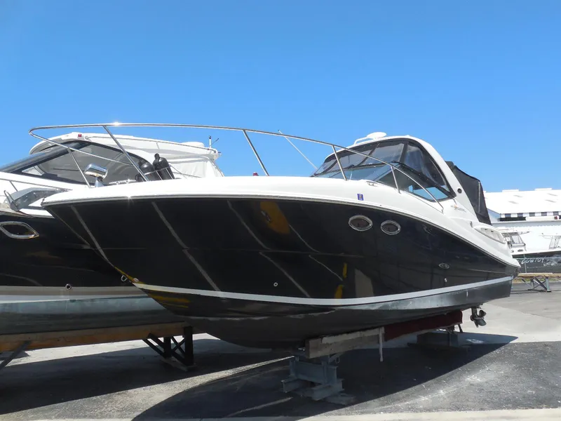 Slide: The Image of 2007 Sea Ray 290 Sundancer boat on display under clear blue sky. - 8