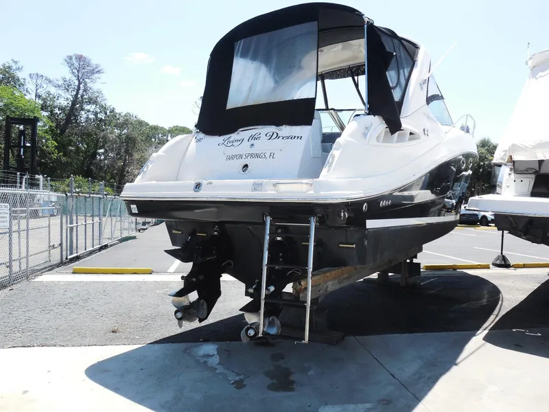 Slide: The Image of 2007 Sea Ray 290 Sundancer boat on trailer, rear view, in a parking area. - 9