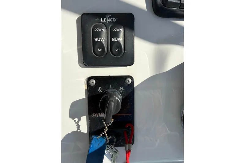 Slide: The Image of Control panel of a 2014 Sea Hunt Triton 220 boat with Lenco trim tab switches. - 11