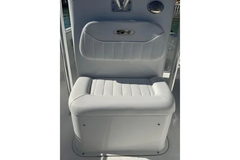 Slide: The Image of 2014 Sea Hunt Triton 220 boat seat with white upholstery and SH logo. - 18
