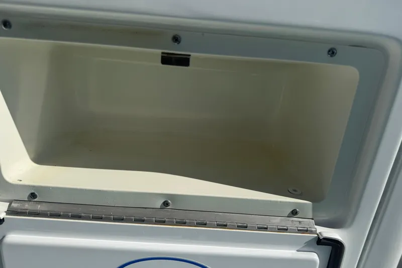 Slide: The Image of Open storage compartment on a 2014 Sea Hunt Triton 220 boat. - 19