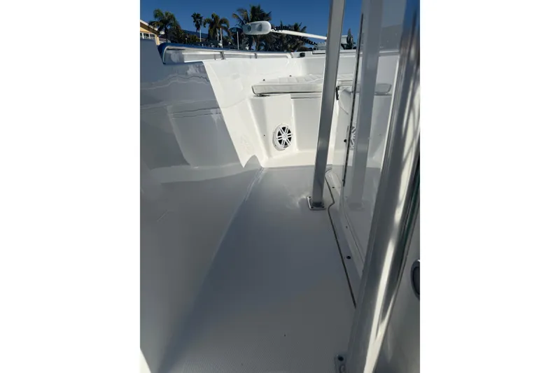 Slide: The Image of 2014 Sea Hunt Triton 220 boat interior with sleek white design and speaker system. - 21
