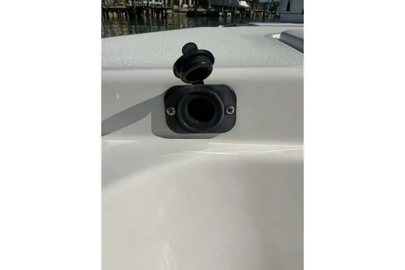 Slide: The Image of 2014 Sea Hunt Triton 220 boat detail with a black socket on the deck. - 28