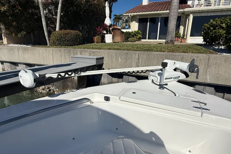 Slide: The Image of 2014 Sea Hunt Triton 220 boat with Minn Kota trolling motor at dockside. - 29