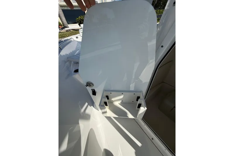 Slide: The Image of 2014 Sea Hunt Triton 220 boat compartment with open hatch, showcasing interior storage. - 35