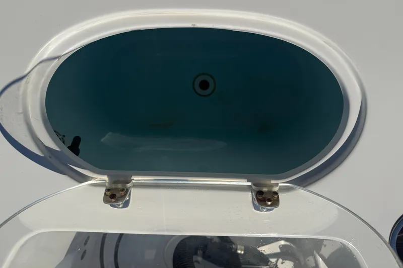Slide: The Image of Open livewell on 2014 Sea Hunt Triton 220 boat, showing interior water. - 37