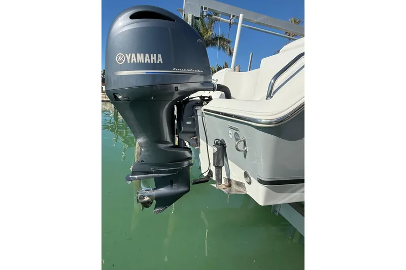 Slide: The Image of 2014 Sea Hunt Triton 220 with Yamaha outboard motor on calm water. - 40
