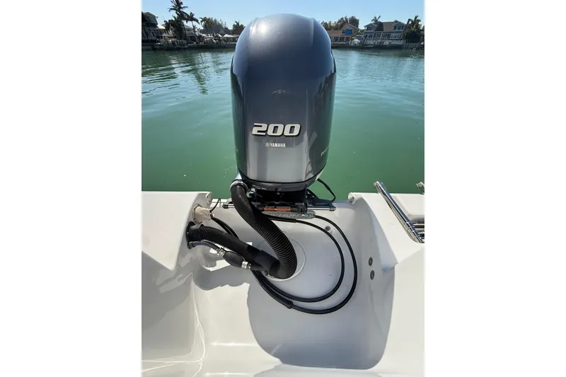Slide: The Image of 2014 Sea Hunt Triton 220 with Yamaha 200 outboard motor on calm water. - 41