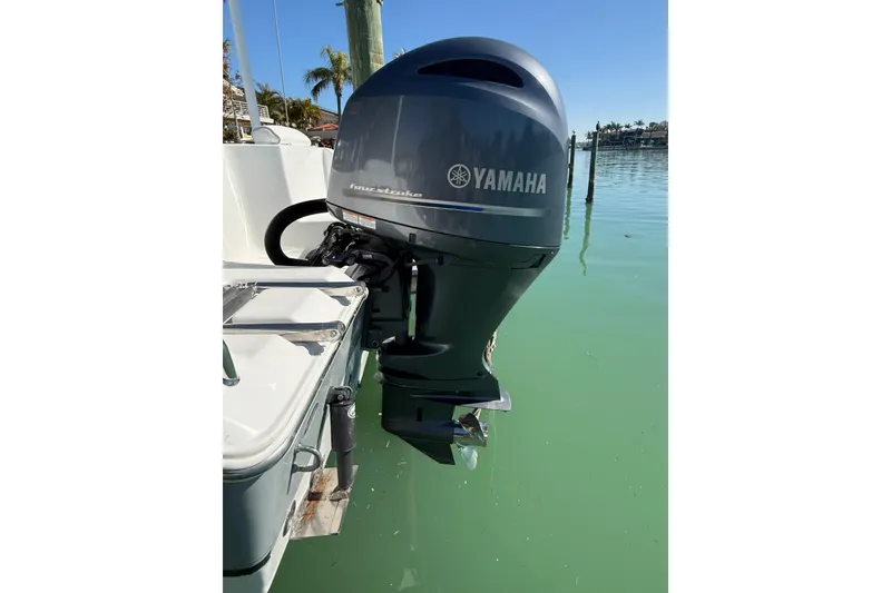 Slide: The Image of Yamaha outboard motor on 2014 Sea Hunt Triton 220 boat, docked in clear water. - 43