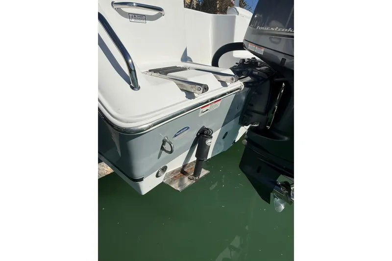 Slide: The Image of 2014 Sea Hunt Triton 220 boat stern with motor in water. - 47