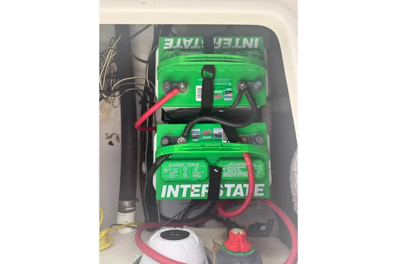 Slide: The Image of Dual Interstate batteries in a 2014 Sea Hunt Triton 220 boat compartment. - 49