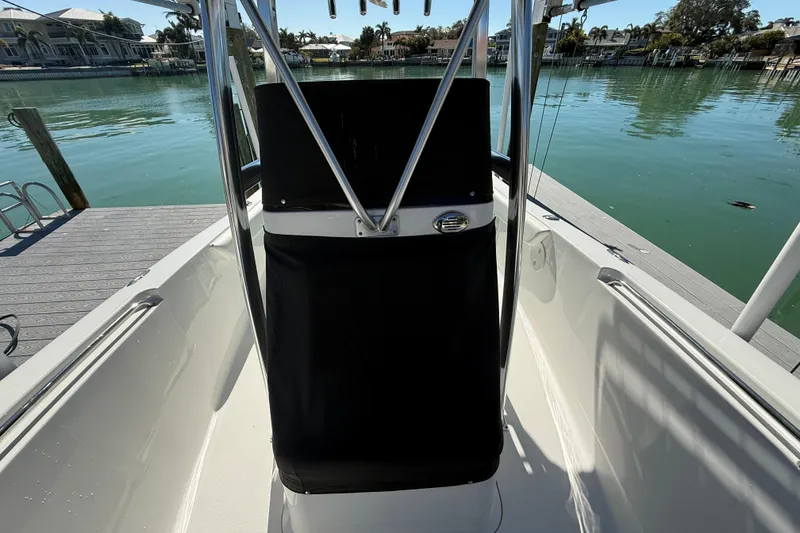 Slide: The Image of 2014 Sea Hunt Triton 220 boat interior with sleek design, docked by calm waters. - 57