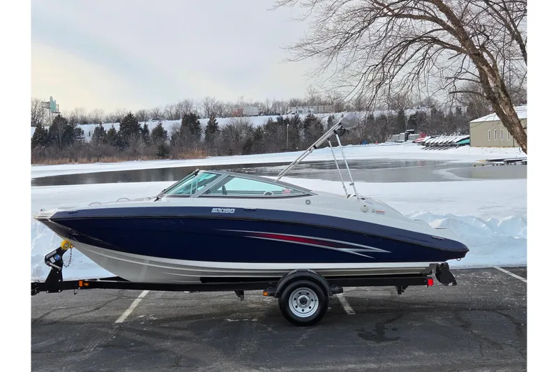 The Image of 2013 Yamaha Boats SX190 on trailer by snowy lakeside, ready for adventure. - 0