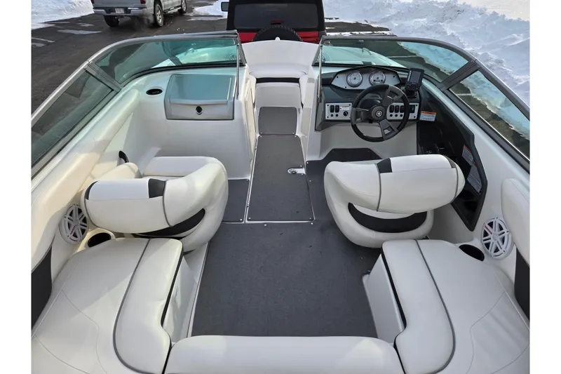Slide: The Image of 2013 Yamaha Boats SX190 interior with white seating and modern dashboard design. - 10