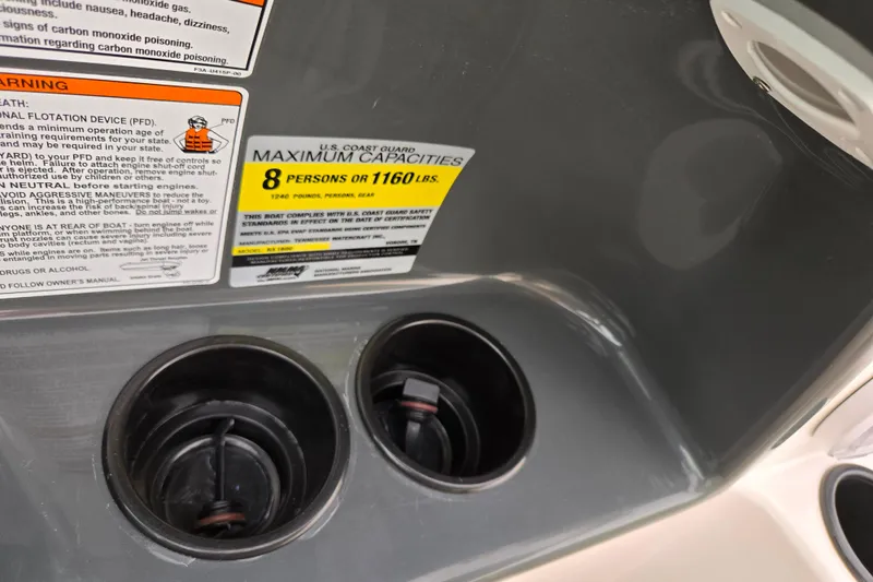 Slide: The Image of 2013 Yamaha Boats SX190 capacity warning labels and cup holders. - 13