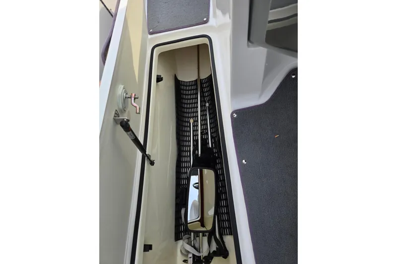 Slide: The Image of 2013 Yamaha Boats SX190 storage compartment with hydraulic lift and carpeted flooring. - 14