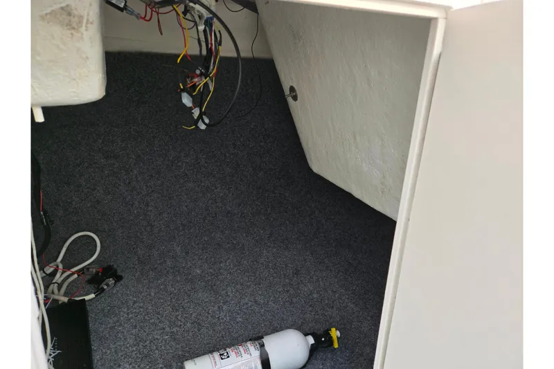 Slide: The Image of Interior of 2013 Yamaha SX190 boat showing wiring and fire extinguisher. - 15