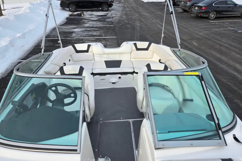 Slide: The Image of 2013 Yamaha Boats SX190 interior with seating, steering wheel, and windshield in snowy parking lot. - 19