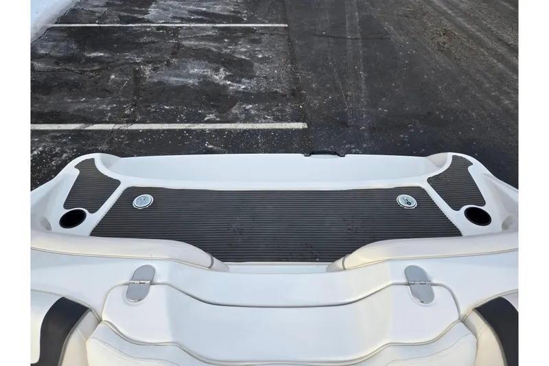Slide: The Image of 2013 Yamaha Boats SX190 swim platform with cup holders and textured surface. - 23