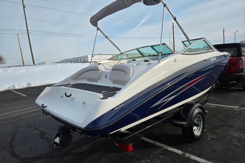 Slide: The Image of 2013 Yamaha Boats SX190 on trailer, parked in snowy lot. - 3