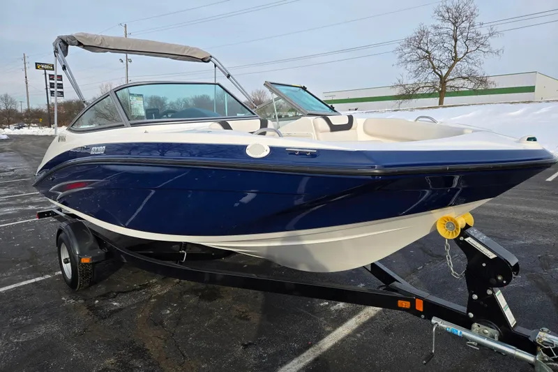 Slide: The Image of 2013 Yamaha Boats SX190 on trailer, blue and white, parked in snowy lot. - 5